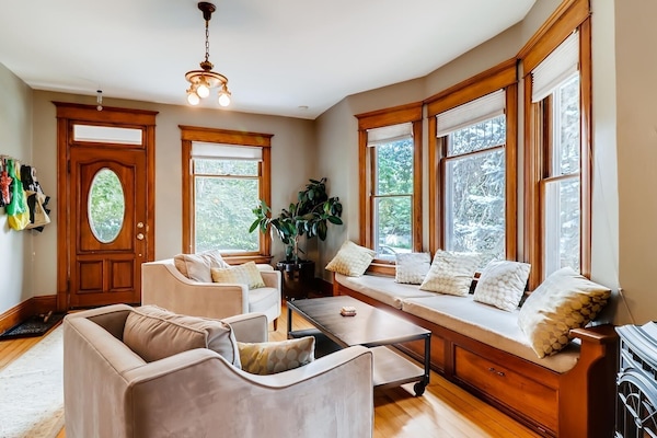 Front living room with fireplace and large windows