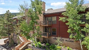 A two-story building with a brick facade, a balcony on the second floor, and a sign that reads "Silver Cliff Village." - The Silver Cliff, 2BR Walk to Lifts and Main St! (Park City)