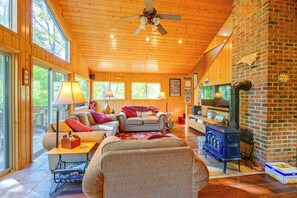 A cozy cabin interior with wooden walls, a fireplace, and a comfortable seating area. - North Carolina Escape w/ Deck, Grill & Fire Pit! (Bryson City)