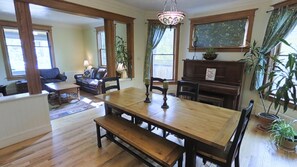 Cozy living area with a large dining table, comfortable seating, and a fireplace.