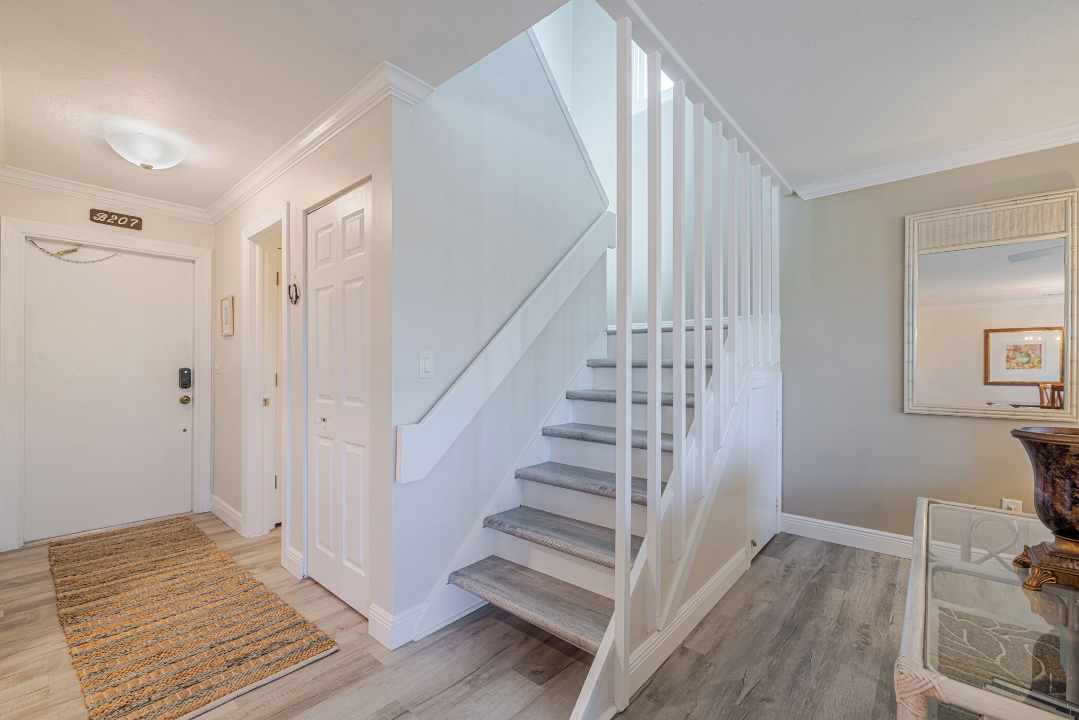 A staircase with white railings leading to a landing.