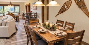 A dining area with a wooden table set for six, surrounded by wooden chairs. - Private Indoor Hot Tub • Ski Views • Walk to Lifts (Keystone)