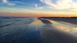 A beach with a calm sea and a clear sky. - Just Steps to the Ocean, Beachfront, House On the Beach, Minutes from Galveston (Freeport)