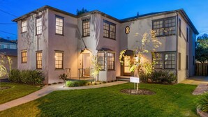 A two-story house with a well-maintained lawn, a front porch, and a 'For Sale' sign. - Universal Hideaway  (Burbank)