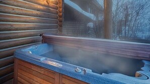 A wooden cabin interior with a hot tub. - Teton Springs Cabin with Private Hot Tub and Air Conditioning (Victor)