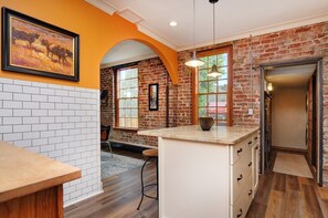 Enjoy cooking in this kitchen with a central island, sink, and countertop, offering a view of the outdoors.