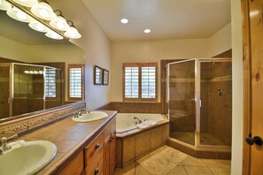 A bathroom with two sinks, a large mirror, a bathtub, and a walk-in shower. - Comfy Large Townhome with private hot tub (Eden)