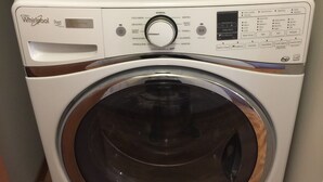 A Whirlpool Duet front-loading washer with a wooden interior panel, control panel, and a transparent door. - Bellevue Retreat - Bellevue,  East of Seattle, WA (Bellevue)