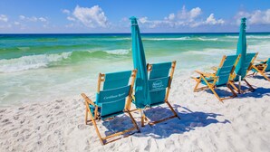 Beach chairs with umbrellas at a resort. - Luxury Corner Unit For The Discriminating Traveler with Double  Beach Service (Navarre)