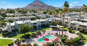 A residential complex with multiple apartment buildings, a swimming pool, and palm trees. - Modern and Peaceful Single Level Condo in Old Town w/Heated Pool! (Scottsdale)