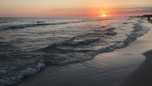 A beach at sunset with waves gently lapping the shore. - Family-Friendly or Romantic Retreat • Pools + Private Beach Access  (Miramar Beach)