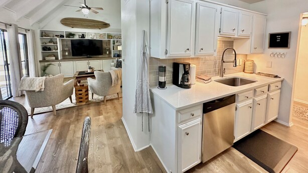 A modern kitchen with white cabinets, a built-in oven, and a stainless steel dishwasher. - Family-Friendly or Romantic Retreat • Pools + Private Beach Access  (Miramar Beach)