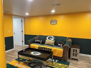 A room with a couch, a coffee table, and a door.