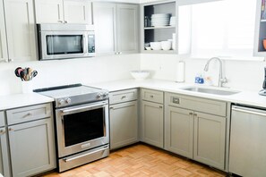 Fridge, microwave, oven, stovetop - Steps from the pool and ocean! Four-level East Beach townhome with elevator! (Saint Simons Island)