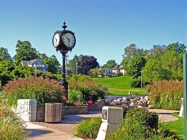 Stunning clock tower stands at the heart of this picturesque neighborhood, surrounded by beautifully manicured gardens and lush greenery.