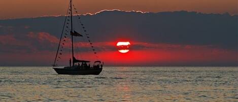 A boat on calm waters during sunset.