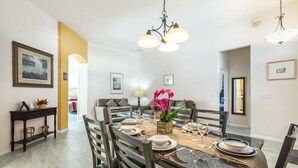 A dining area with a marble table, chairs, and a chandelier. - 💥💥$40 OFF SALE TOP RATED  ALL-INCLUSIVE HOME. NEAR DISNEY PRIME LOCATION 💥💥 (Davenport)