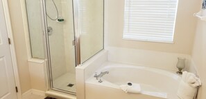 Bathtub, hair dryer, towels, toilet paper