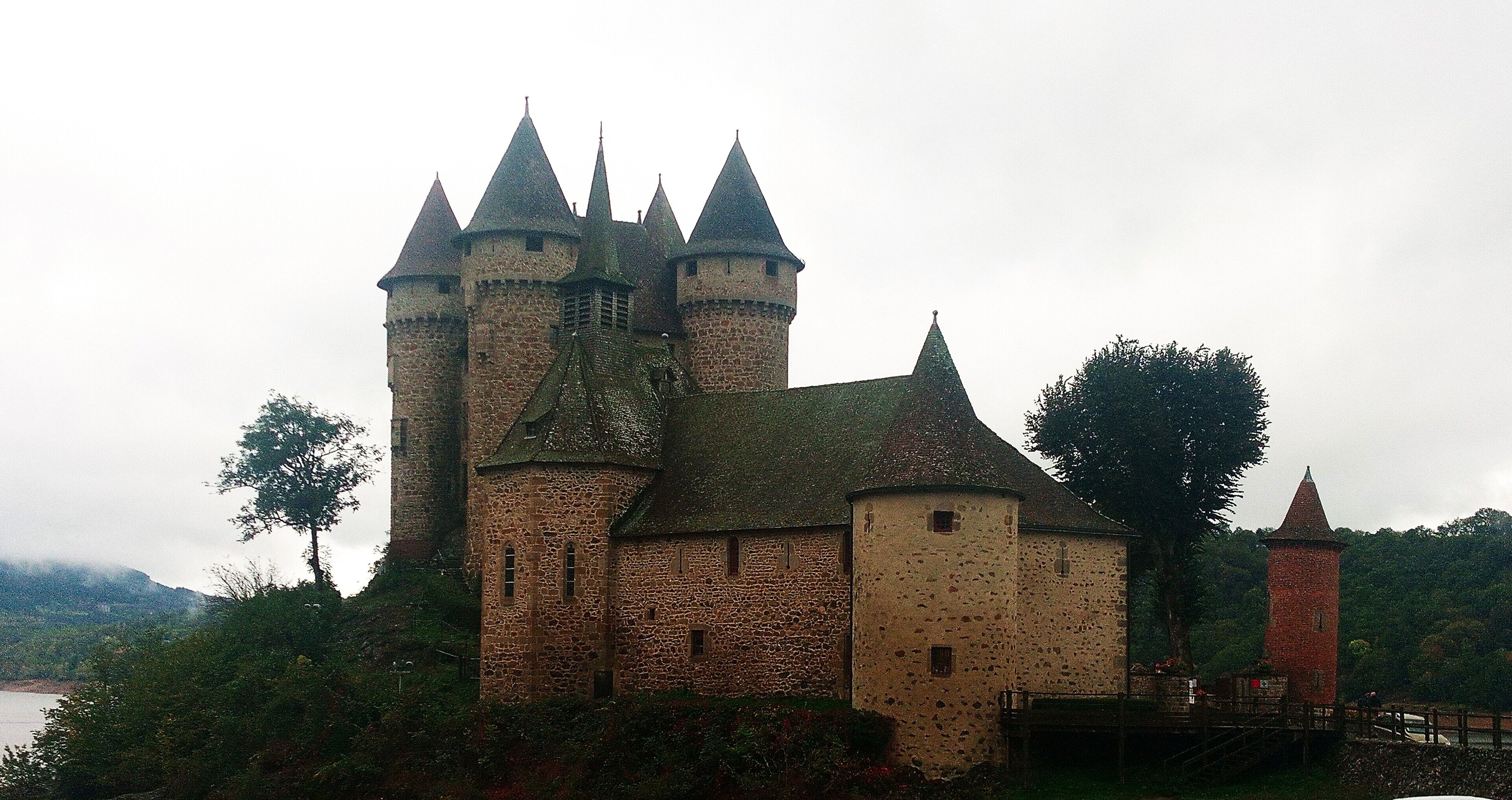 A historic castle with multiple towers and a moat.