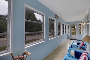 Relax in this serene room with a view of the surrounding greenery, featuring a comfortable seating area and a large window.