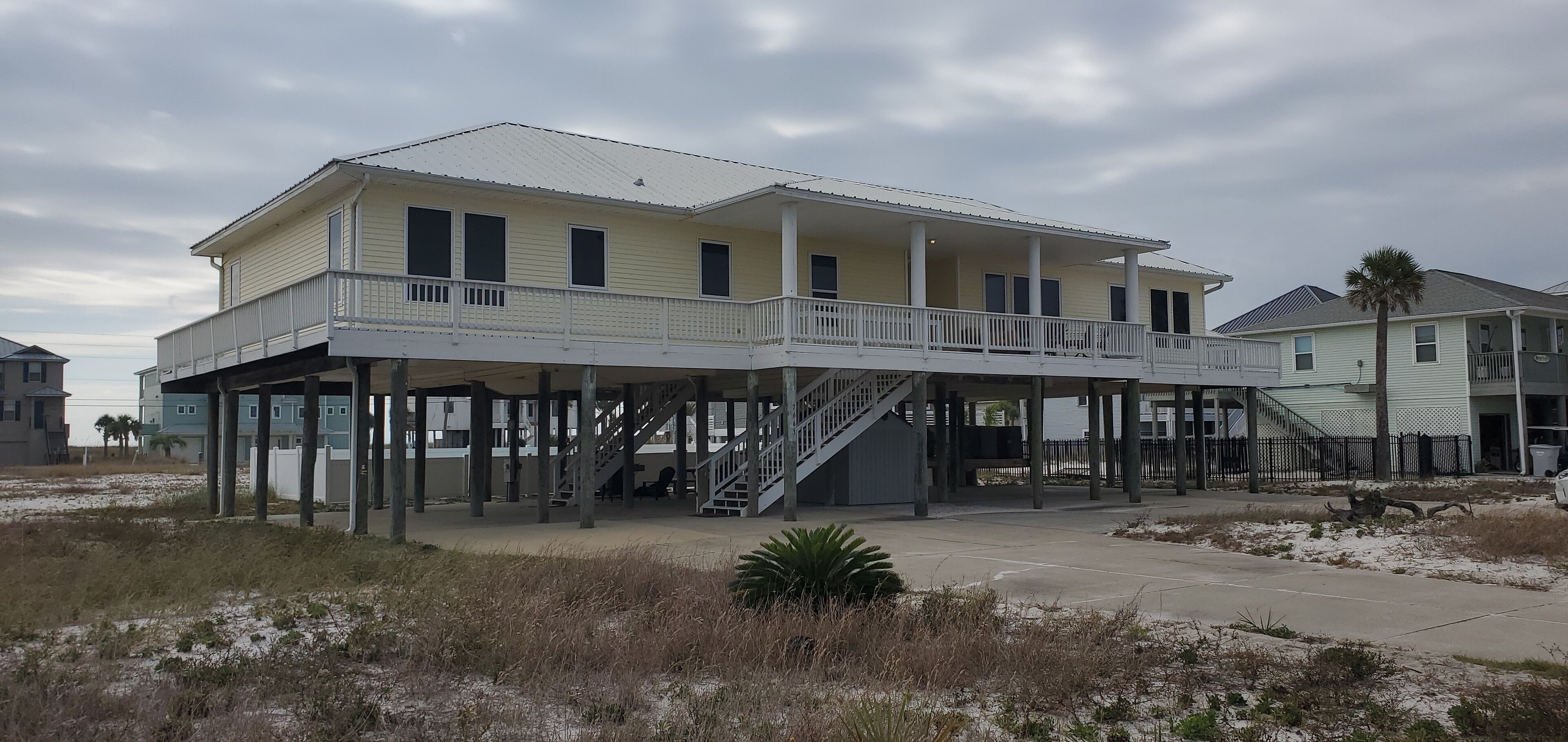 A two-story house with a balcony and a covered walkway.