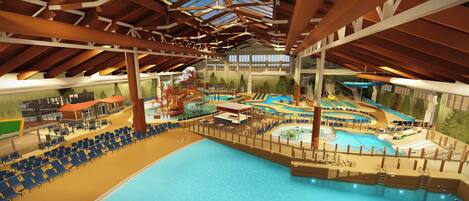 Une piscine intérieure dotée de plusieurs couloirs de nage, d’un toboggan et d’un espace de jeux.