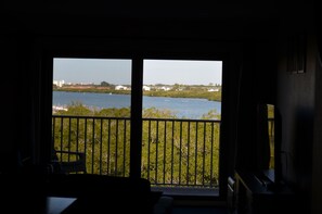 Enjoy a serene view of the water from the balcony with a large window.