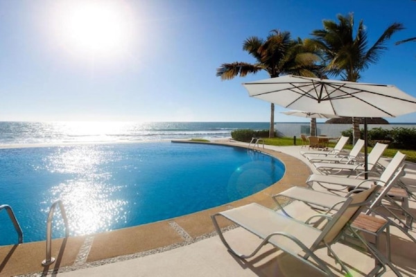 Infinity pool with lounge chairs