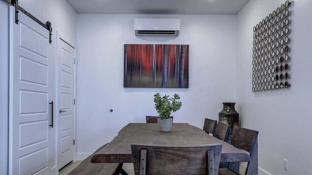 A dining area with a wooden table, benches, and a potted plant. - The Lofts #7 | Townhome Pool Resort | Poolside (Saint George)