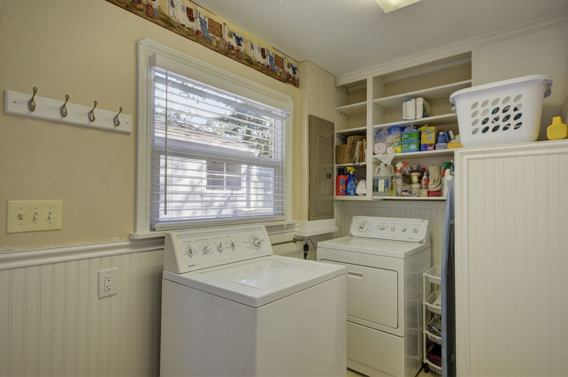 Complete laundry room with supplies incl iron & ironing board plus a steamer. 