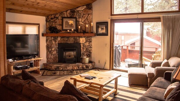 A cozy living room with a stone fireplace, a television, and comfortable seating. - 2 Bedroom 2 bath end unit pet friendly condo in the  (mammoth lakes)