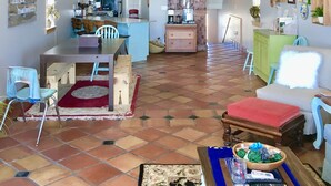 A spacious living area with a high ceiling, a dining area, and a kitchen. - Beach Front Sleeps 10 Walking distance to everything (St. George Island)