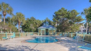 A pool area with lounge chairs, a gazebo, and a wooden deck. - Walk to Beach or Pool-2 Bikes/Match Pointe CH (Santa Rosa Beach)