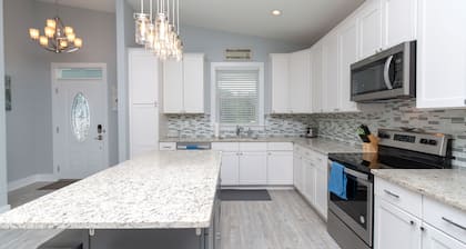 Beach house with gorgeous views, private green space, and steps to the beach.