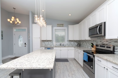 Beach house with gorgeous views, private green space, and steps to the beach.