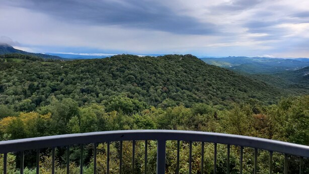 A mountainous landscape with dense forest coverage and a cloudy sky. - Affordable Rate with a Priceless View! (Sugar Mountain)