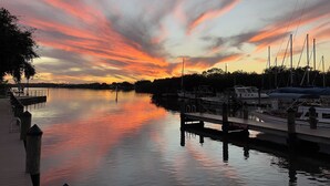 A marina with boats docked, a wooden dock, and a calm water body reflecting the sky. - Casa la Cala - Serious Fun + Luxury Relaxation! (Safety Harbor)