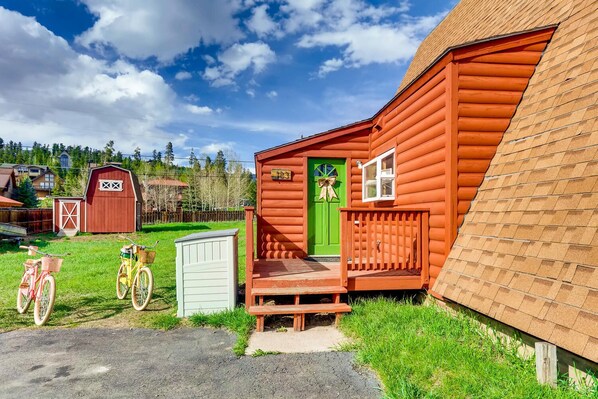 A wooden cabin with a green door, a porch, and a bicycle parked outside. - Mountain Views, Hot Tub, Incredible Location! Dog Friendly!
BCA-47331 (Dillon)