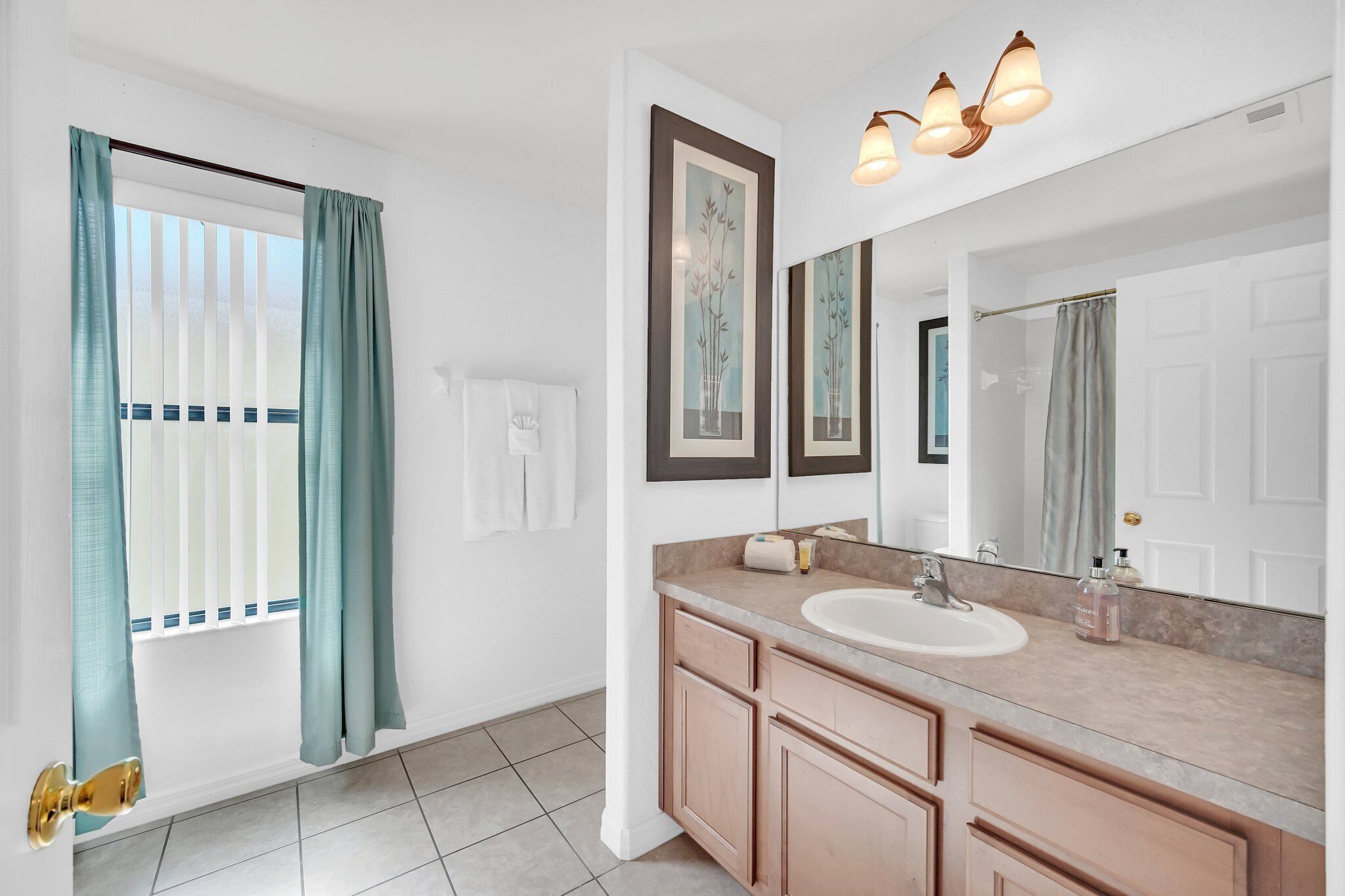 A modern bathroom with a large mirror, a sink, and a vanity.