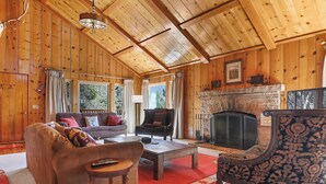 A cozy wooden interior with a fireplace, a sofa, a chair, and a coffee table. - Historic Author's Lodge- Hot Tub as Featured in San Diego Magazine Walk to town. (Idyllwild)