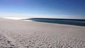 A beach with a clear sky and calm sea. - Sept 15-19 Reduced! Steps to the Beach & Tootsies! (Panama City Beach)