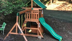 A wooden play structure with a slide and swings in a garden area. - 1ST FLR APT Your Private Resort, now FAMILY-ized: 1 BR + LR suitable for 2 kids  (Shelton)