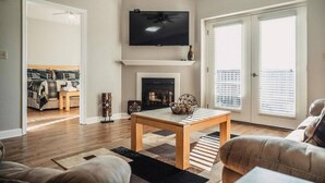 A living room with a fireplace, a television, and a dining area. - Sweet Berry Patch-Unit 3706 - FREE Attraction Ticket with EACH night Stay Including Dollywood (Pigeon Forge)