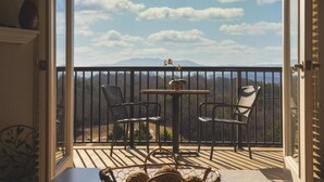 A balcony with two chairs and a small table, overlooking a mountainous landscape. - Sweet Berry Patch-Unit 3706 - FREE Attraction Ticket with EACH night Stay Including Dollywood (Pigeon Forge)
