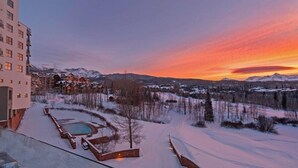 A resort with a pool area, surrounded by snow-covered landscape and mountains. - Unbeatable Views in 3 Bedroom Penthouse - Great Location (Mountain Villlage)