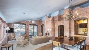 A spacious living area with a fireplace, a dining table, and comfortable seating. - Unbeatable Views in 3 Bedroom Penthouse - Great Location (Mountain Villlage)