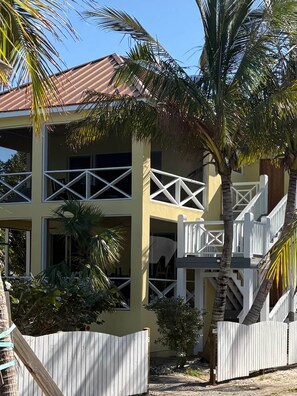 A two-story building with a balcony and a staircase.
