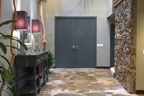 Entry way with live trees and skylights.