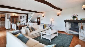 A living room with a sofa, coffee table, and fireplace. - Provencal villa located in serene setting with panoramic views, sleeps 12 (Le Bar-sur-Loup)