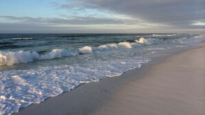 A beach with waves crashing onto the shore and a clear sky above. - STUNNING GULF FRONT VIEW! (Destin)